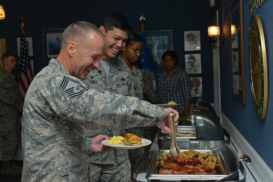 U.S. Air Force Chief Master Sgt. Dilbert Areford, 20th Equipment Maintenance Squadron superintendent, serves himself food during a Women’s Equality Day Breakfast at Shaw Air Force Base, S.C., Aug. 26, 2016. Women’s Equality Day was established in 1971 to commemorate the passing of the 19th Amendment, which granted women the right to vote. (U.S. Air Force photo by Airman 1st Class Destinee Sweeney)