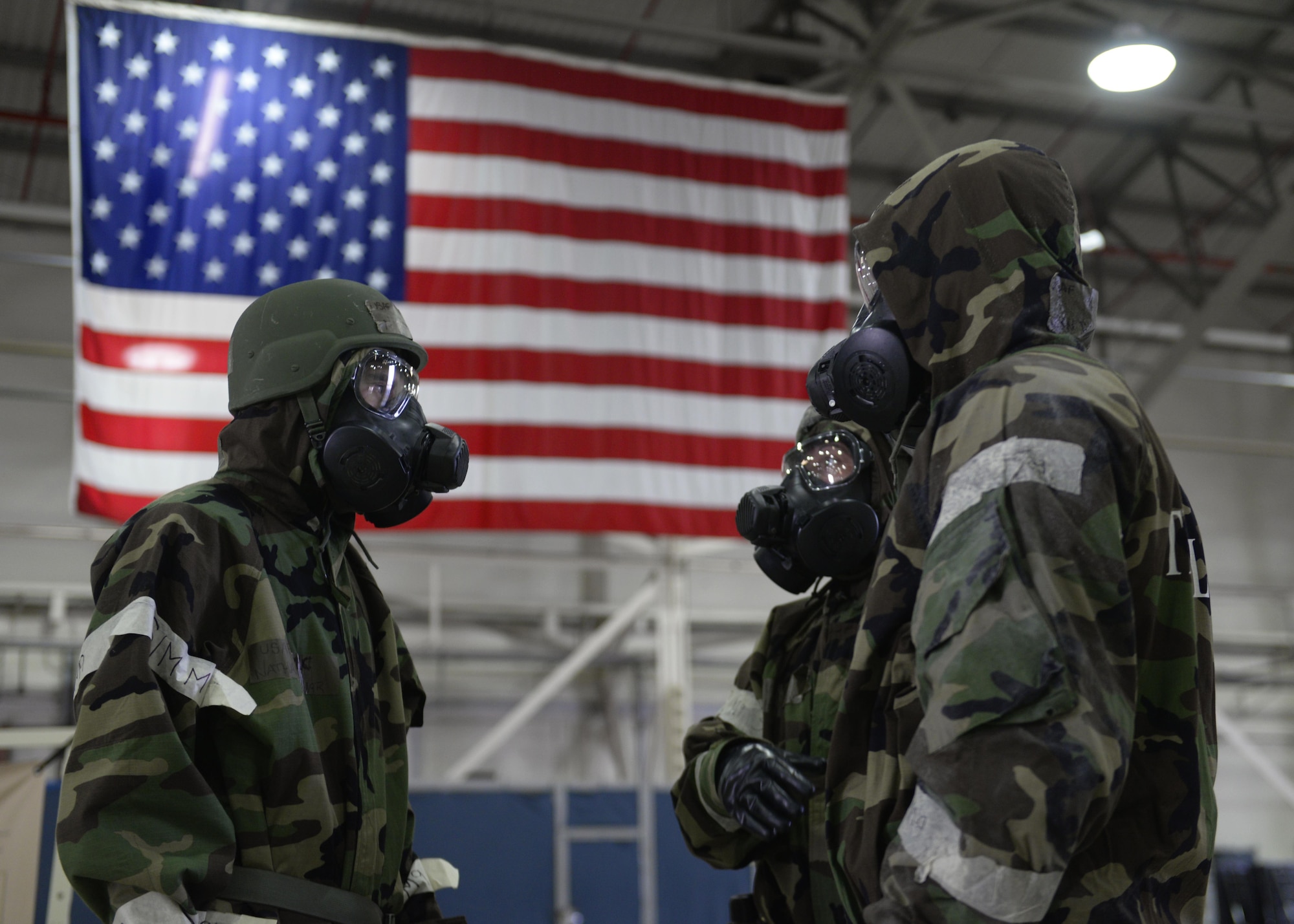 U.S. Air Forces in Europe aircrew flight equipment technicians bring a flight crew member to a decontamination station at Royal Air Force Lakenheath, England, Aug. 25. AFE technicians from every USAFE base participated in the Chemical Defense Mobility Exercise. (U.S. Air Force photo/ Airman 1st Class Abby L. Finkel) 