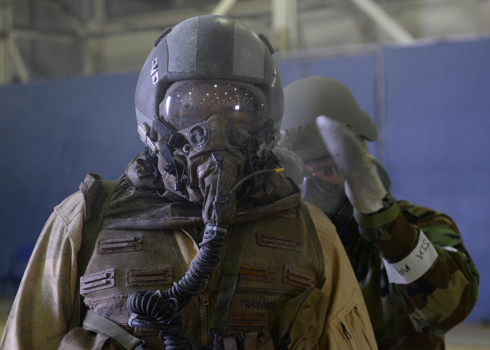A 48th Fighter Wing flight crew member goes through a decontamination process during an exercise at Royal Air Force Lakenheath, England, Aug. 25. The exercise allowed U.S. Air Forces in Europe aircrew flight equipment technicians to practice decontaminating aircrew exposed to chemical, biological, radiological or nuclear contaminates. (U.S. Air Force photo/ Airman 1st Class Abby L. Finkel) 