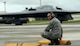 U.S. Air Force Staff Sgt. Staff Sgt. Kory Stanton, a dedicated crew chief assigned to the 509th Aircraft Maintenance Squadron, adjusts chock blocks as a B-2 pilots taxis to a halt Aug. 23, 2016 at Andersen Air Force Base, Guam. The United States maintains a strong, credible bomber force that enhances the security and stability of allies and partners. (U.S. Air Force photo by Senior Airman Jovan Banks) 