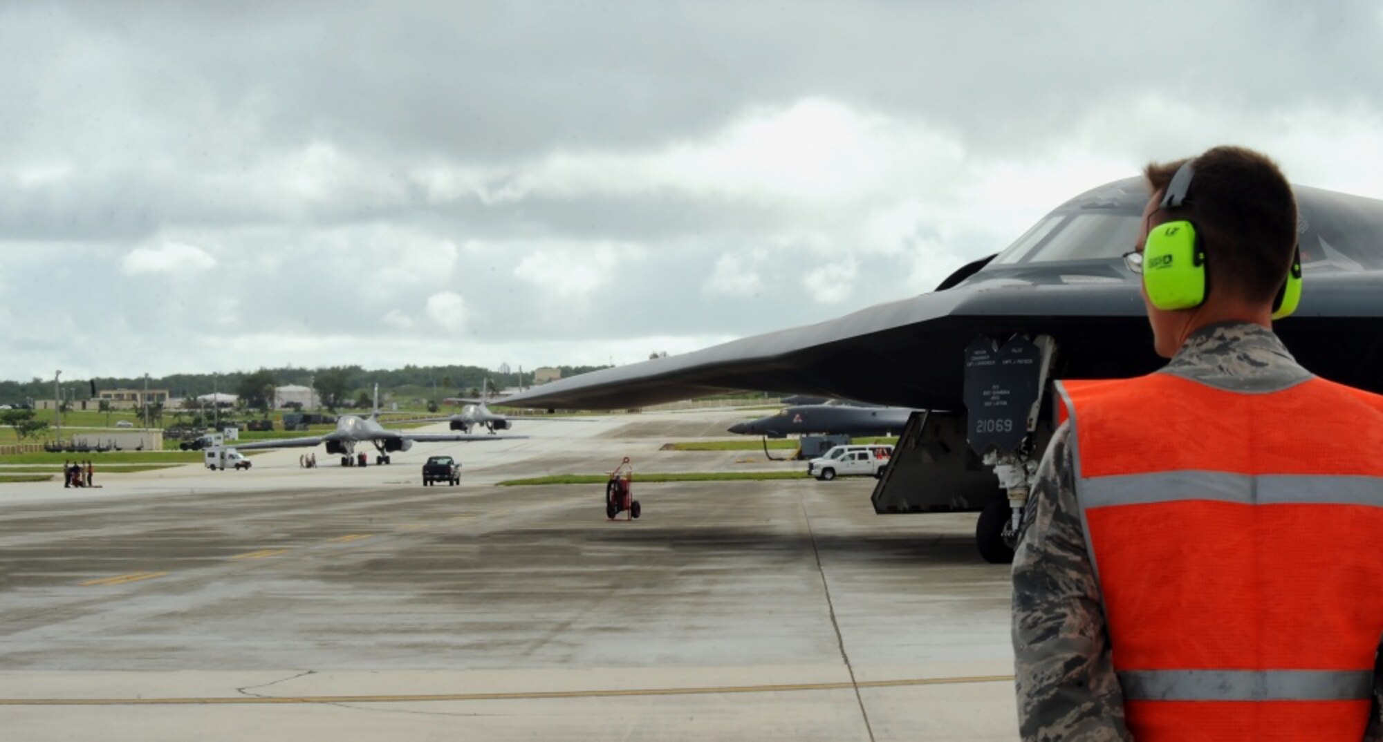 U.S. Air Force Staff Sgt. Matthew Helms, a dedicated crew chief assigned to the 509th Aircraft Maintenance Squadron, prepares to marshal a B-2 Spirit onto the runway Aug. 22, 2016 at Andersen Air Force Base, Guam. Thanks to its subsonic speeds and it’s nearly 7,000 mile un-refueled range, the B-2 Spirit is capable of bringing massive firepower, in a short time, anywhere on the globe through the most challenging defenses. (U.S. Air Force photo by Senior Airman Jovan Banks)  