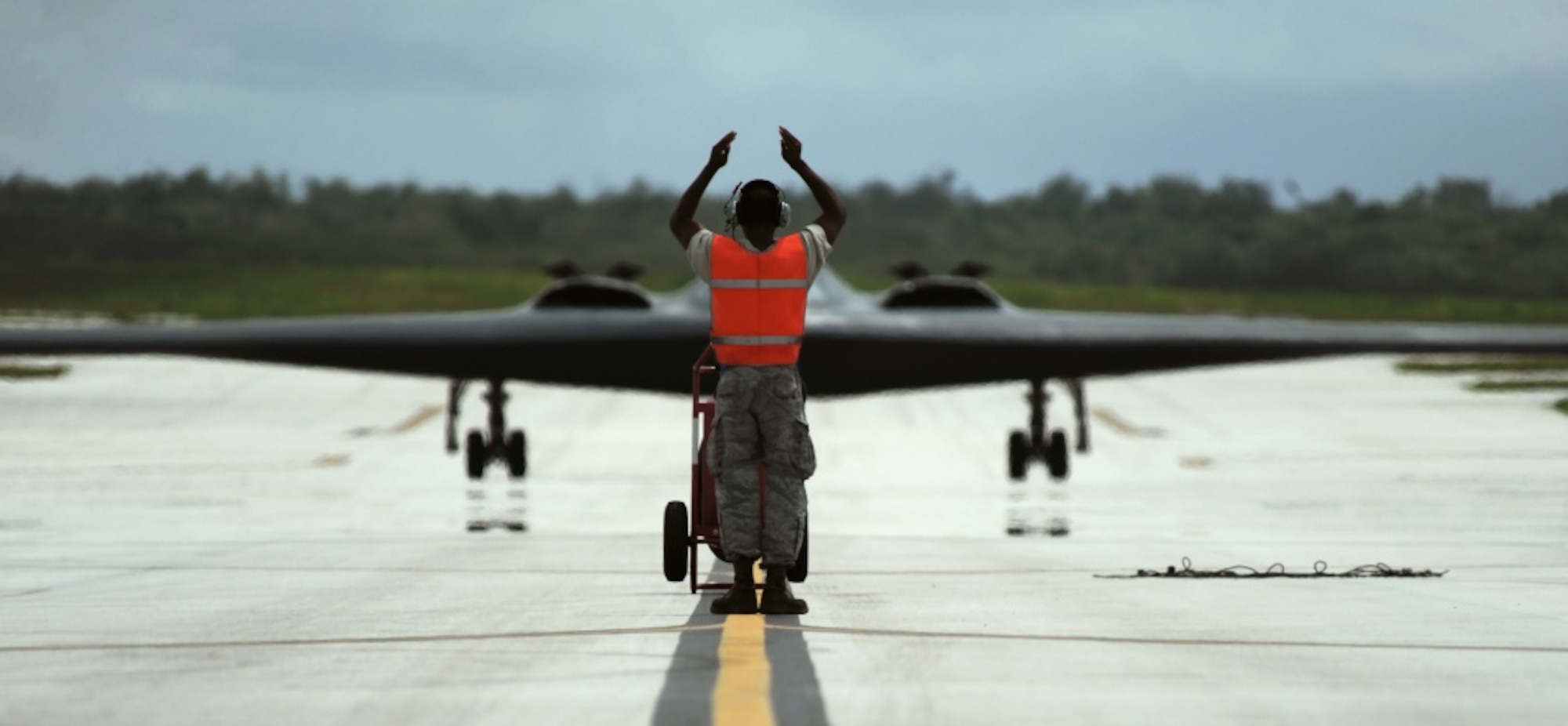 U.S. Air Force Senior Airman Harris, a crew chief assigned to the 509th Aircraft Maintenance Squadron, taxis in a B-2 Spirit aircraft Aug. 24, 2016 at Andersen Air Force Base, Guam. Bomber operations provide a visible demonstration of the U.S. ability to project power globally and respond to any potential crisis or challenge. (U.S. Air Force photo by Senior Airman Jovan Banks)