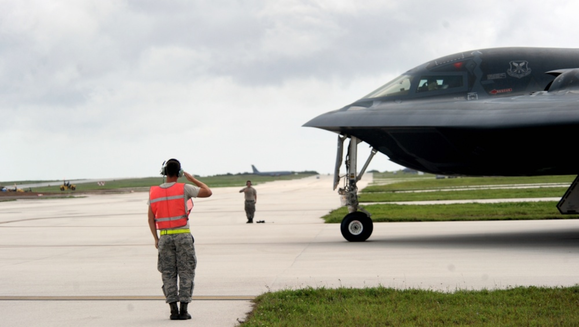 U.S. Air Force Staff Sgt. Matthew Helms, left, and Staff Sgt. Joshua Layton, both dedicated crew chiefs assigned to the 509th Aircraft Maintenance Squadron, salute pilots of a B-2 Spirit aircraft as they begin to taxi onto the runway Aug. 22, 2016 at Andersen Air Force Base, Guam. Thanks to its subsonic speeds and it’s nearly 7,000 mile un-refueled range, the B-2 Spirit is capable of bringing massive firepower, in a short time, anywhere on the globe through the most challenging defenses. (U.S. Air Force photo by Senior Airman Jovan Banks) 