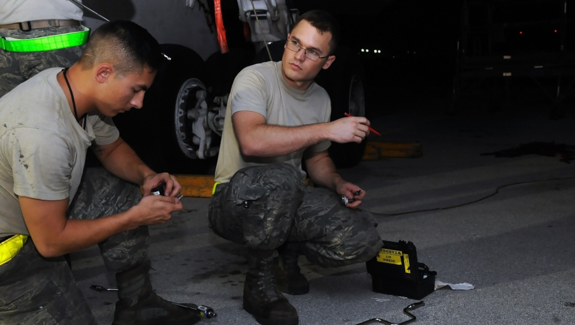 U.S. Air Force Senior Airman Evan Miesner, right, an electrical and environmental journeyman and Senior Airman Tyler Pham Vo, an aerospace propulsion journeyman, both assigned to the 509th Aircraft Maintenance Squadron, gather tools to perform maintenance on a B-2 Spirit aircraft Aug. 24, 2016. Bomber operations provide a unique and complementary capability to the Intercontinental Ballistic Missile and Ballistic Missile Submarine legs of the triad that underpins strategic deterrence. (U.S. Air Force photo by Senior Airman Jovan Banks) 