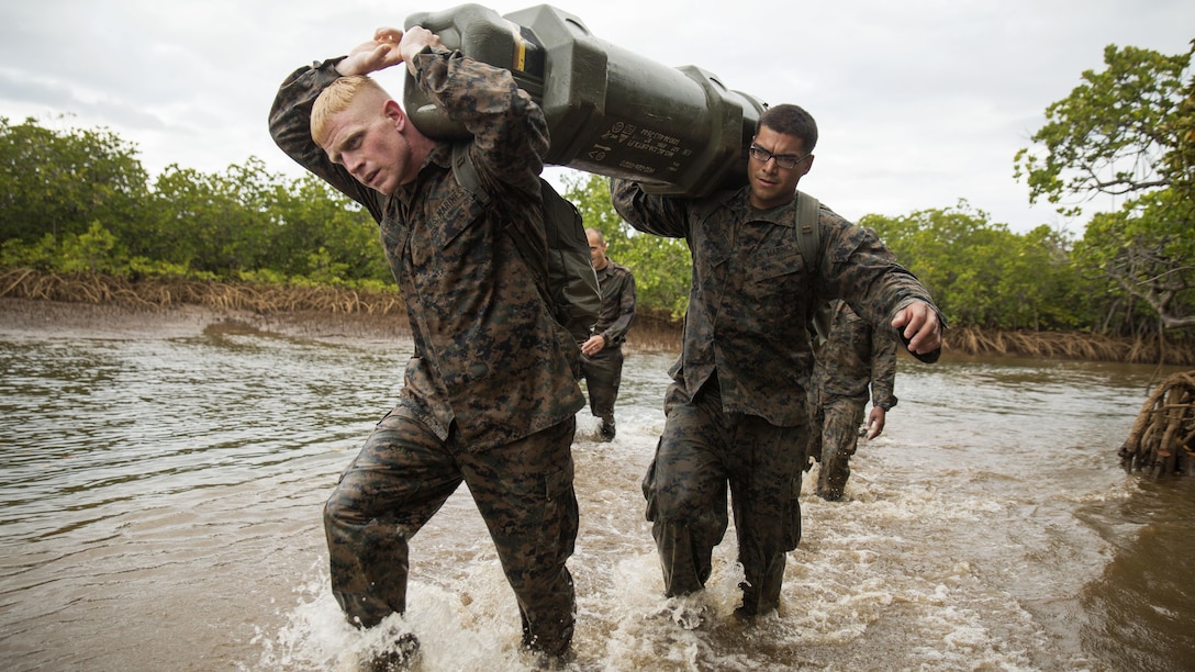 1st Lt. Ian M. Cameron, left, an infantry officer, and Cpl. Alfredo Ibarra, right, a rifleman, transport ammo through mangroves during a French Armed Forces Nautical Commando Course in Noumea, New Caledonia, August 22, 2016. The course is a part of Exercise AmeriCal 16, a bilateral training exercise designed to enhance mutual combat capabilities and improve relations between the U.S. Marine Corps and the French Armed Forces. Cameron, from Rochester, Minnesota, and Ibarra, from Laredo, Texas, are with Marine Rotational Force - Darwin.