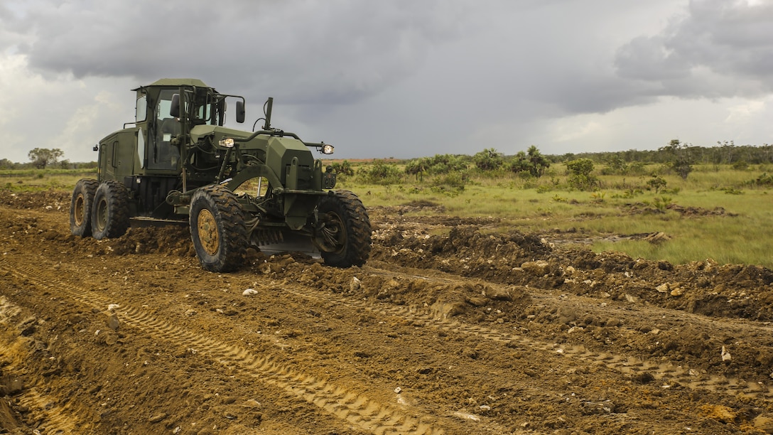 A U.S. Marine with Marine Wing Support Detachment 31, in support of Special Purpose Marine Air-Ground Task Force - Southern Command, uses a 120M Grader to dig a drainage system for a road under repair at the Hattieville Range Complex in Hattieville, Belize, Aug. 24, 2016. Over the next several months, Marines from MWSD-31 will be working on several engineer projects in Belize, which will help to increase partner nation capacity and strengthen regional defense and security cooperation.