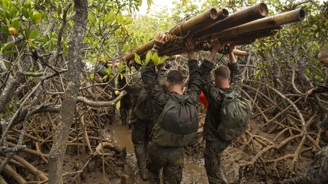 Marines with Marine Rotational Force – Darwin transport a water raft through mangroves during a French Armed Forces Nautical Commando Course in Noumea, New Caledonia, August 22, 2016. The course is a part of Exercise AmeriCal 16, a bilateral training exercise designed to enhance mutual combat capabilities and improve relations between the U.S. Marine Corps and the French Armed Forces.