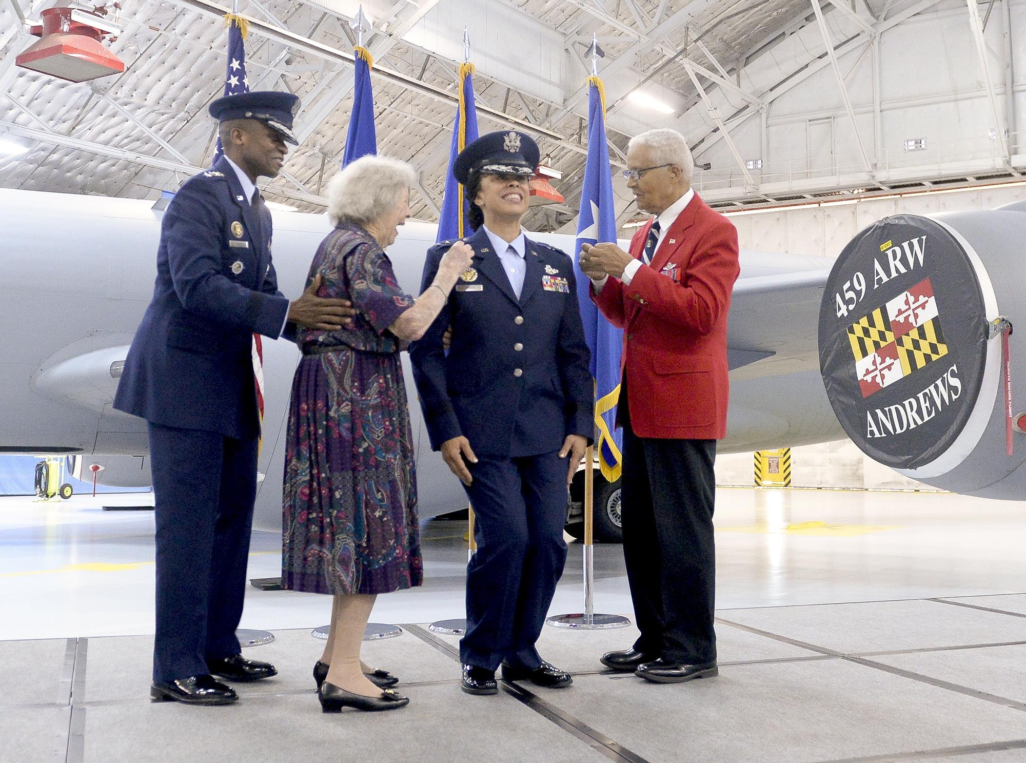 Gen. Darren W. McDew, the U.S. Transportation Command commander, watches as former Women Airforce Service Pilot Pauline Cutler-White and retired Col. Charles McGee, one of the original Tuskegee Airmen, pin new rank on Lt. Gen. Stayce D. Harris during her promotion ceremony Aug. 26, 2016, at Joint Base Andrews, Md. Harris became the Air Force's first black female lieutenant general, and also the first reservist to fill the position of the assistant vice chief of staff and director of the air staff. (U.S. Air Force photo/Andy Morataya)