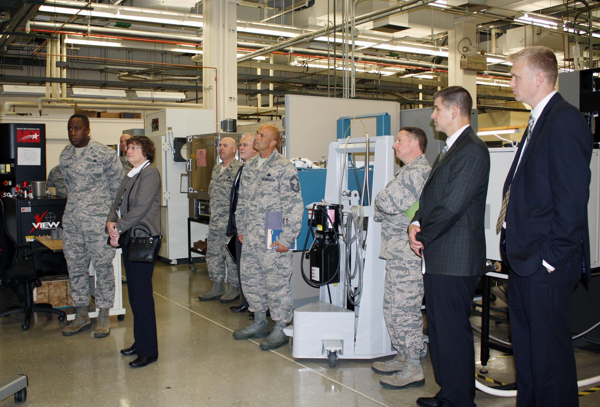 WRIGHT-PATTERSON AIR FORCE BASE, Ohio – Brig. Gen. Stacey T. Hawkins, Director, Logistcs, Engineering and Force Protection, Air Mobility Command (left) and Dr. Donna C. Senft, Chief Scientist, Air Mobility Command, along with core members of the aircraft maintenance team visited the Materials and Manufacturing Directorate, Air Force Research Laboratory, to gain in-depth knowledge of additive manufacturing capabilities and technologies, Aug. 26. The visit included a directorate overview, discussions on additive manufacturing applications and visits to multiple research laboratories, highlighting 3-D printing capabilities for metals, polymer-based materials and functional material applications. AMC is exploring the possibilities of using additive manufacturing as a cost-saving option for replacement parts for aircraft during the life-cycle maintenance process. (Air Force photo by Marisa Novobilski/released)