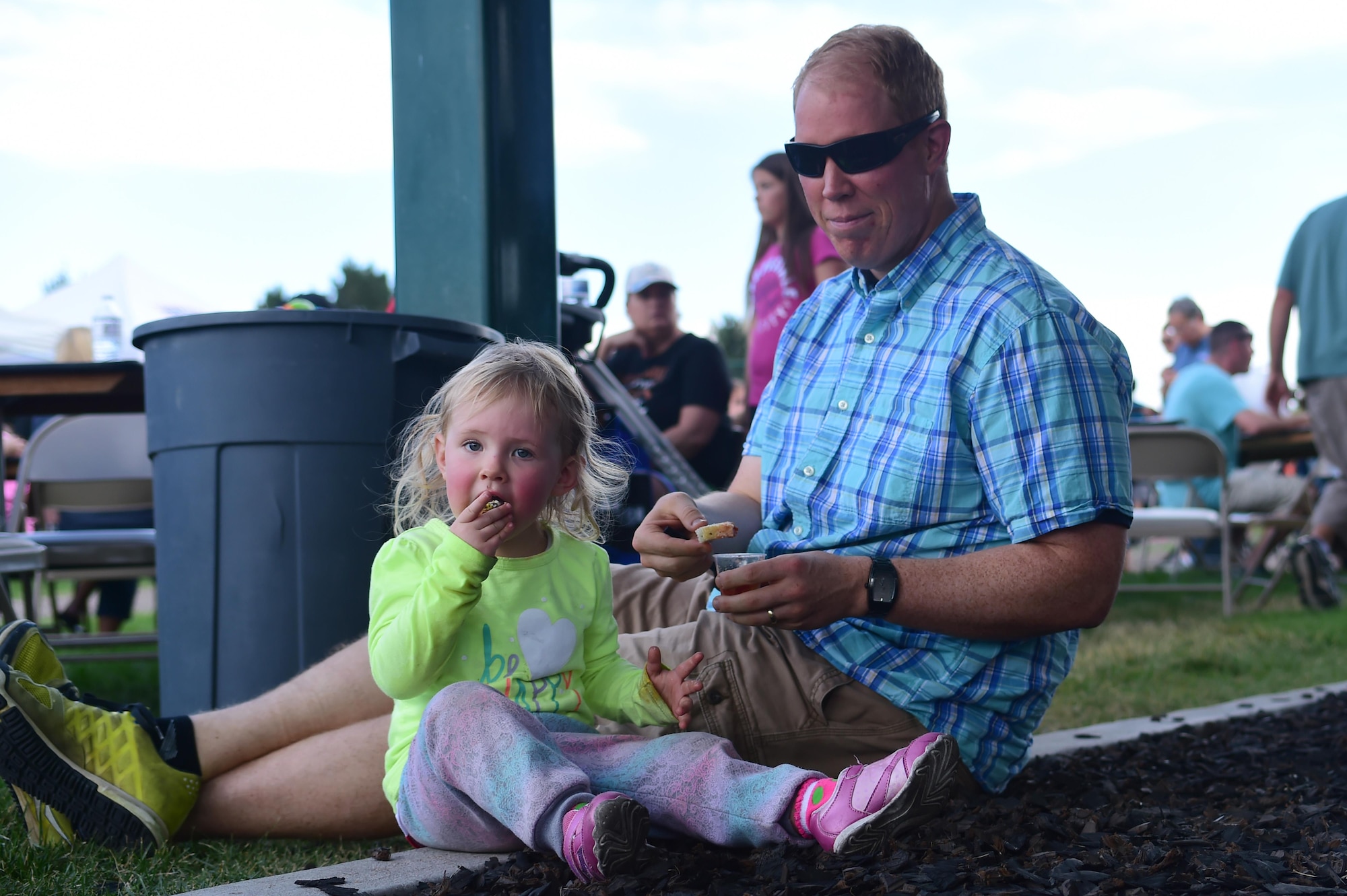 Capt. David Edsen, Aerospace Data Facility Colorado commander’s executive officer, sits with his daughter Lily at FunFest Aug. 26, 2016, on Buckley Air Force Base, Colo. FunFest provided members of the Buckley community with a variety of different attractions for all ages to enjoy. (U.S. Air Force photo by Senior Airman Luke W. Nowakowski/Released)