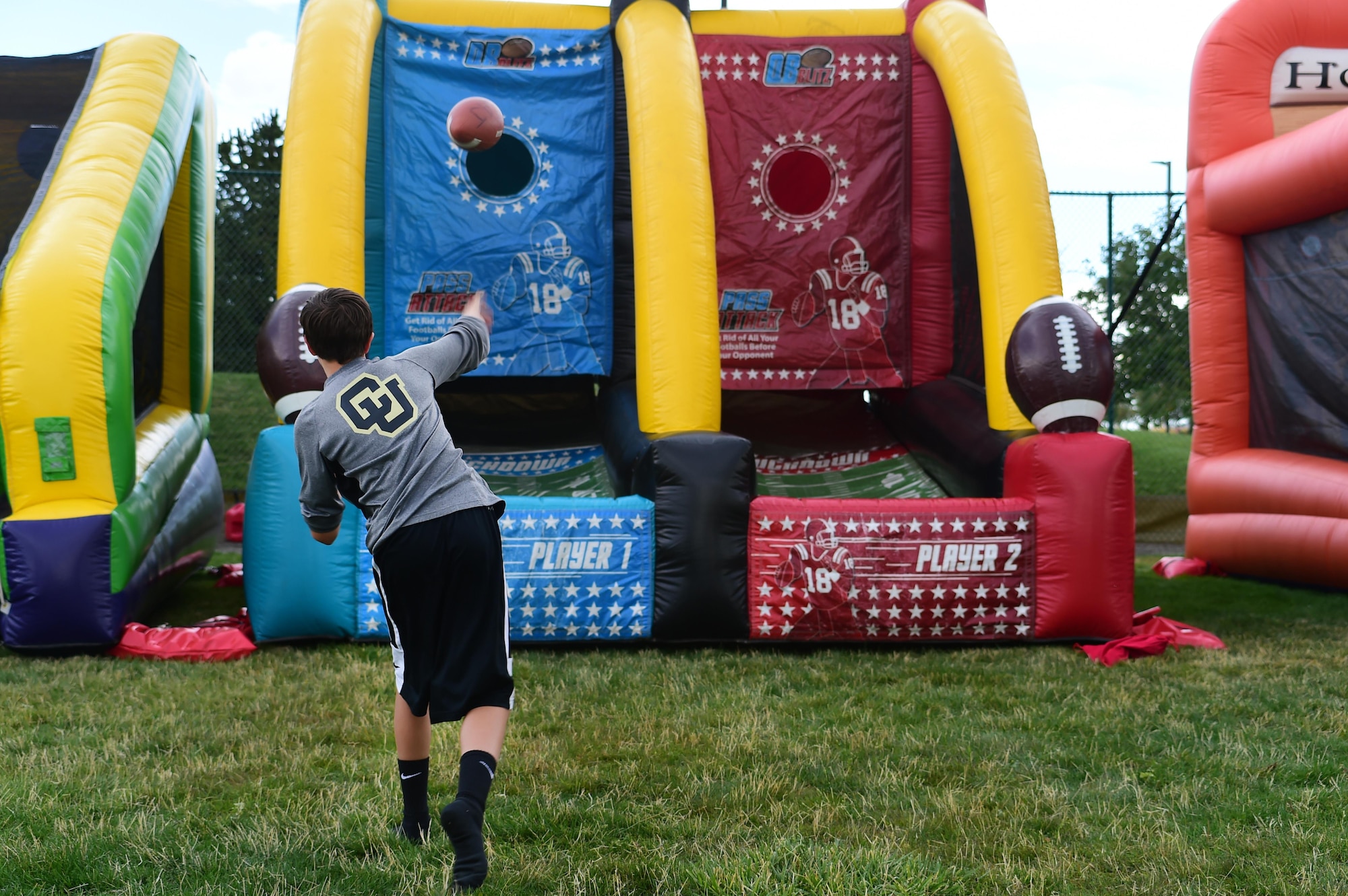 A Buckley Air Force Base child, throws a football at a target during FunFest Aug. 26, 2016, on Buckley AFB, Colo. FunFest is an annual community fair held on Buckley that includes food, games and other attractions for base members. (U.S. Air Force photo by Senior Airman Luke W. Nowakowski/Released)