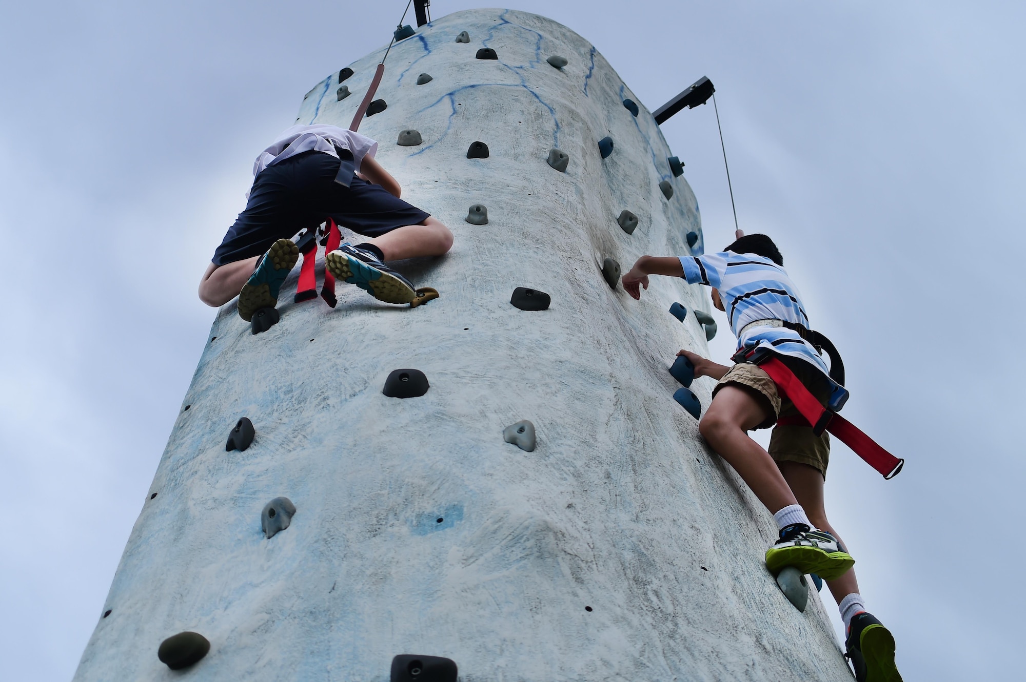 Buckley Air Force Base children, climb a rock wall during FunFest Aug. 26, 2016, on Buckley AFB, Colo. Dozens of games and attractions were set up in order to entertain the Buckley community in attendance during FunFest. (U.S. Air Force photo by Senior Airman Luke W. Nowakowski/Released)