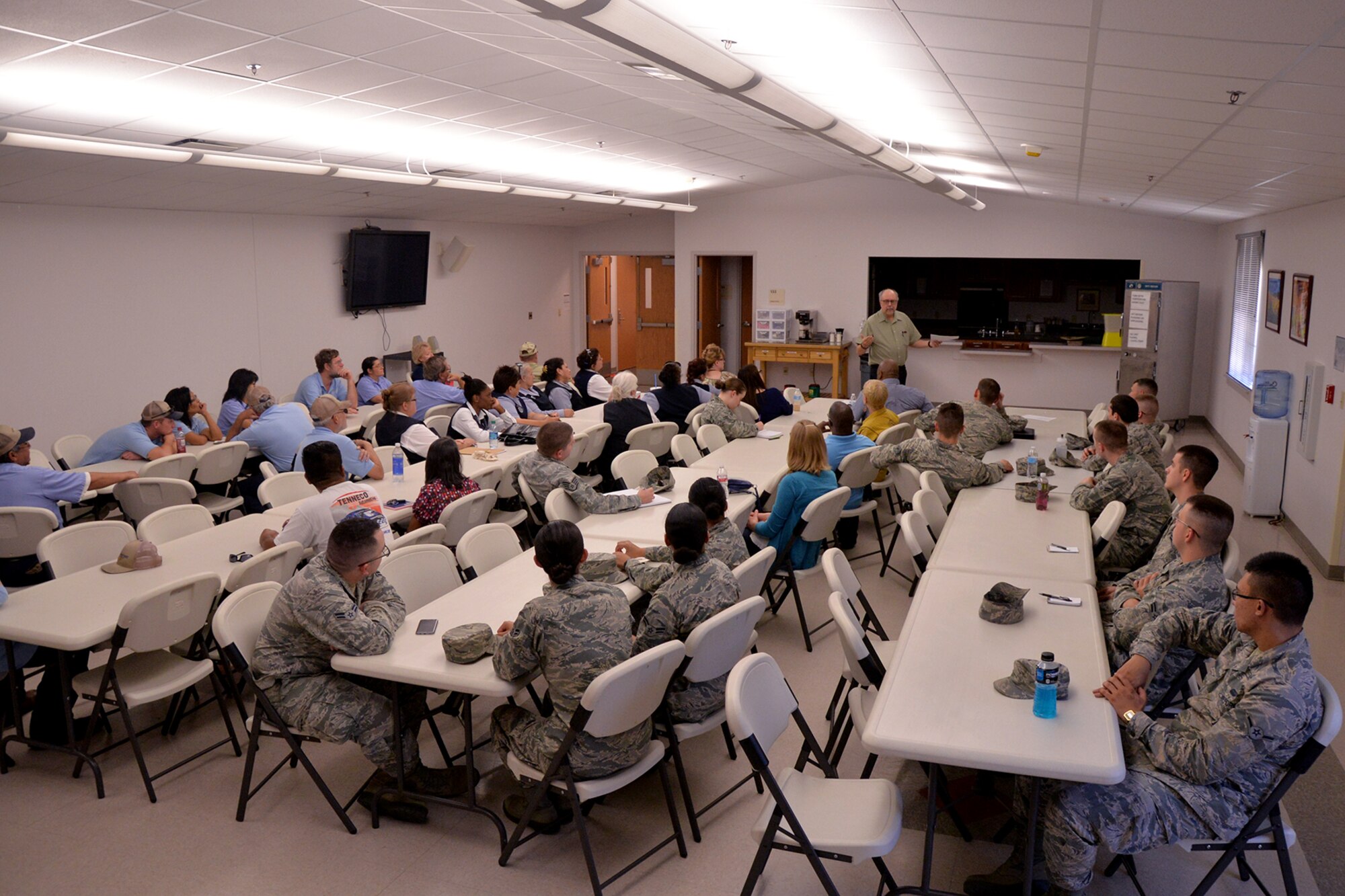 Goodfellow members discuss telephone etiquette at the Taylor Chapel on Goodfellow Air Force Base, Texas, Aug. 11, 2016. Gary Jackson, 17th Force Support Squadron instructor, said that when you smile as you speak, you insert a note of positivity into the interaction. (U.S. Air Force photo by Airman 1st Class Randall Moose/Released)