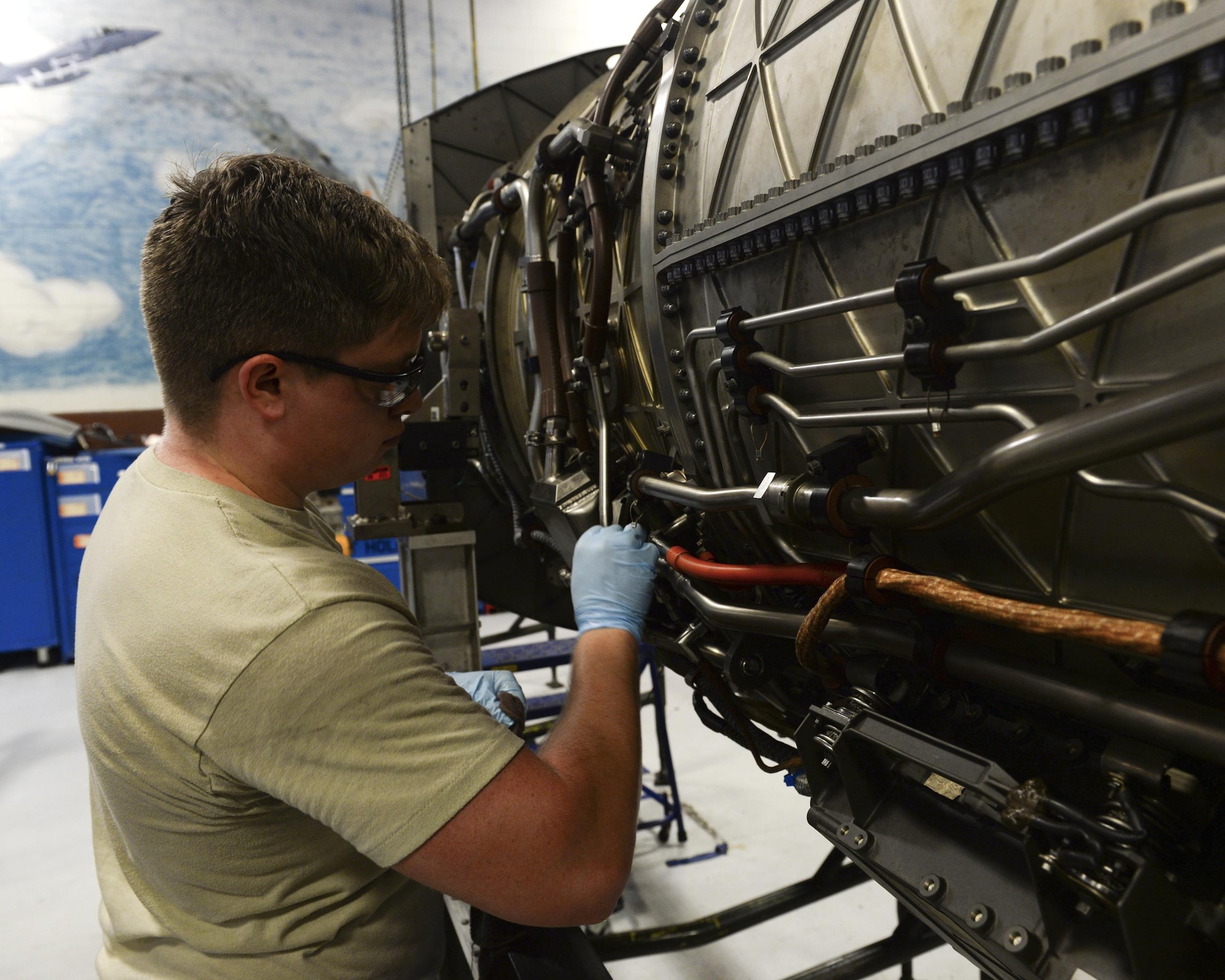 U.S. Air Force Airman 1st Class Derrek Ashmore, 325th Maintenance Squadron aerospace propulsion technician, cleans the side of an F-119 engine in the Propulsion Flight hangar at Tyndall Air Force Base, Fla., Aug. 29, 2016. Aerospace propulsion technicians test, maintain and repair all parts of the engines used to power the F-22 Raptor. (U.S. Air Force photo by Airman 1st Class Cody R. Miller/Released)