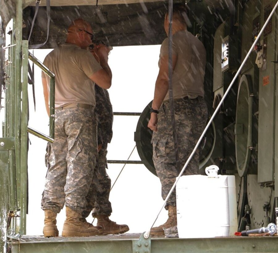 Army Reserve Sgt. David Chapa explains the proper way to stabilize the laundry advance system and ways to minimize the effects if it were to become unbalanced during annual training. Chapa, part of the 340th Quartermaster Company is in the process of becoming an officer in the Army Reserve. Army Reserve photo by Sgt. Michael Adetula 