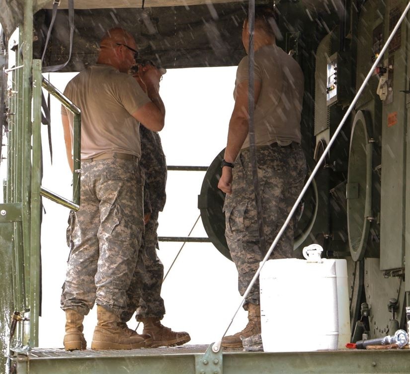 Army Reserve Sgt. David Chapa explains the proper way to stabilize the laundry advance system and ways to minimize the effects if it were to become unbalanced during annual training. Chapa, part of the 340th Quartermaster Company is in the process of becoming an officer in the Army Reserve. Army Reserve photo by Sgt. Michael Adetula 