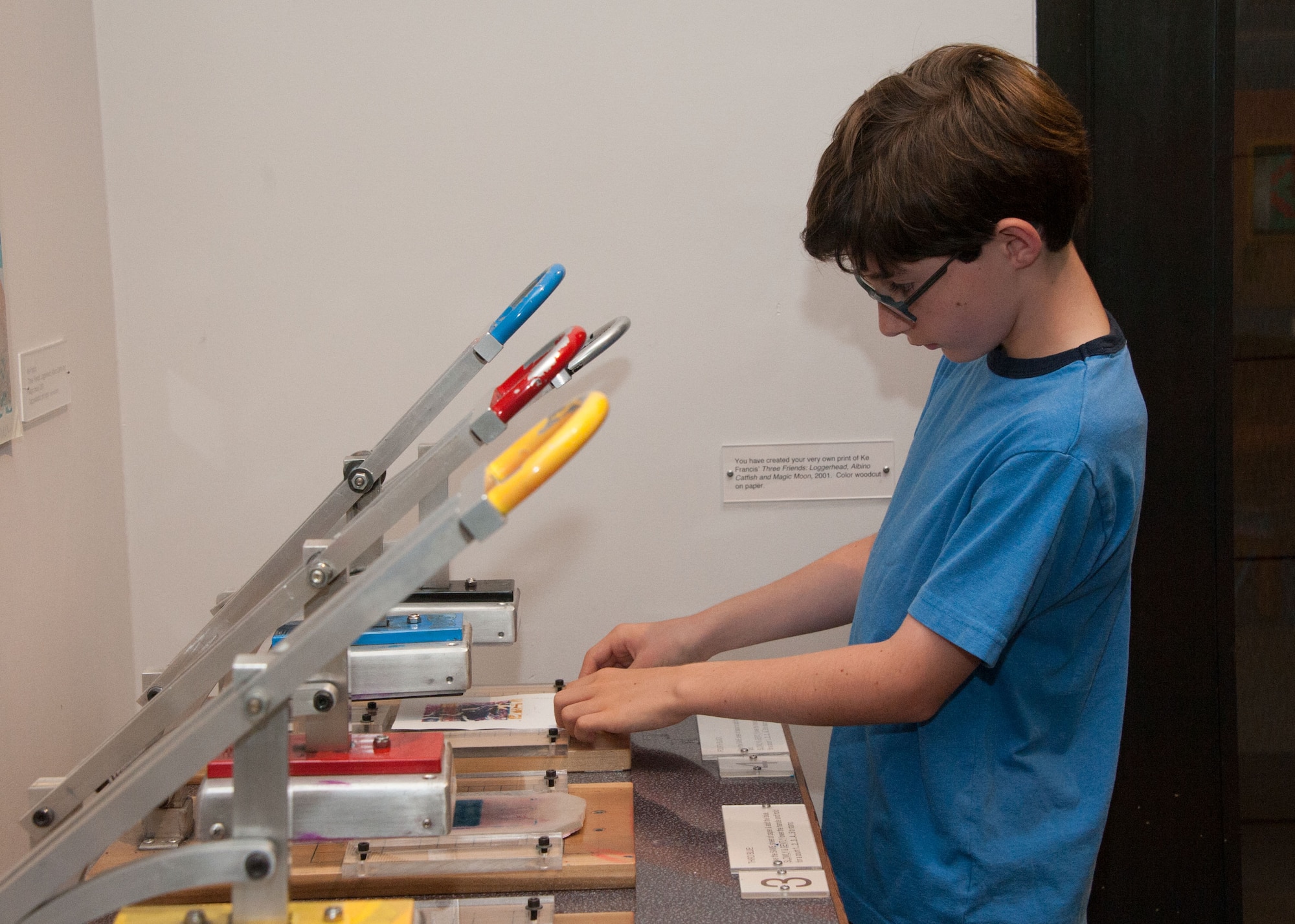 The Annual Open House for Military was held at the Montgomery Museum of Fine Arts, August 25, 2016.  Cade Corbin, son of Major Rebecca Corbin, student at Air Command and Staff College makes a print using the interactive setting at the museum.  (US Air Force photo by Bud Hancock)