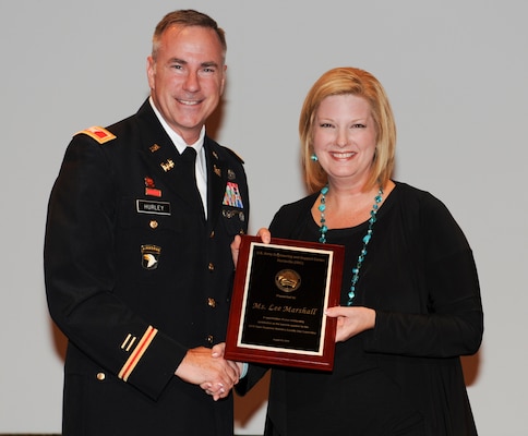 Huntsville Center Commander Col. John Hurley presents Lee Marshall, Kids to Love Foundation CEO, with a token of appreciation for her Women’s Equality Day remarks focusing on foster children who strive for equality with the foundation’s help.  Huntsville Center sponsored the Team Redstone observance celebrating the ratification of the 19th amendment to the U.S. Constitution granting women the right to vote and the contributions women have made toward full equality in the United States.

