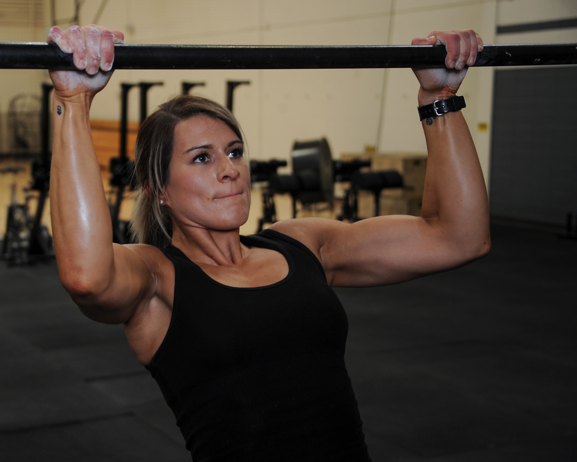 U.S. Air Force Staff Sgt. Macy Benjamin, 355th Contracting Squadron contract administrator, performs a pullup at the Haeffner Fitness and Sports Center at Davis-Monthan Air Force Base, Ariz., Aug. 25, 2016. During her deployment, one of Benjamin's goals was to be able to perform unassisted pullups by the time she returned to the U.S. (U.S. Air Force photo by Airman 1st Class Ashley N. Steffen)