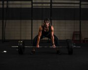U.S. Air Force Staff Sgt. Macy Benjamin, 355th Contracting Squadron contract administrator, prepares to perform a dead lift at the Haeffner Fitness and Sports Center at Davis-Monthan Air Force Base, Ariz., Aug. 25, 2016. Benjamin uses weightlifting as a personal escape from everyday stressors. (U.S. Air Force photo by Airman 1st Class Ashley N. Steffen)