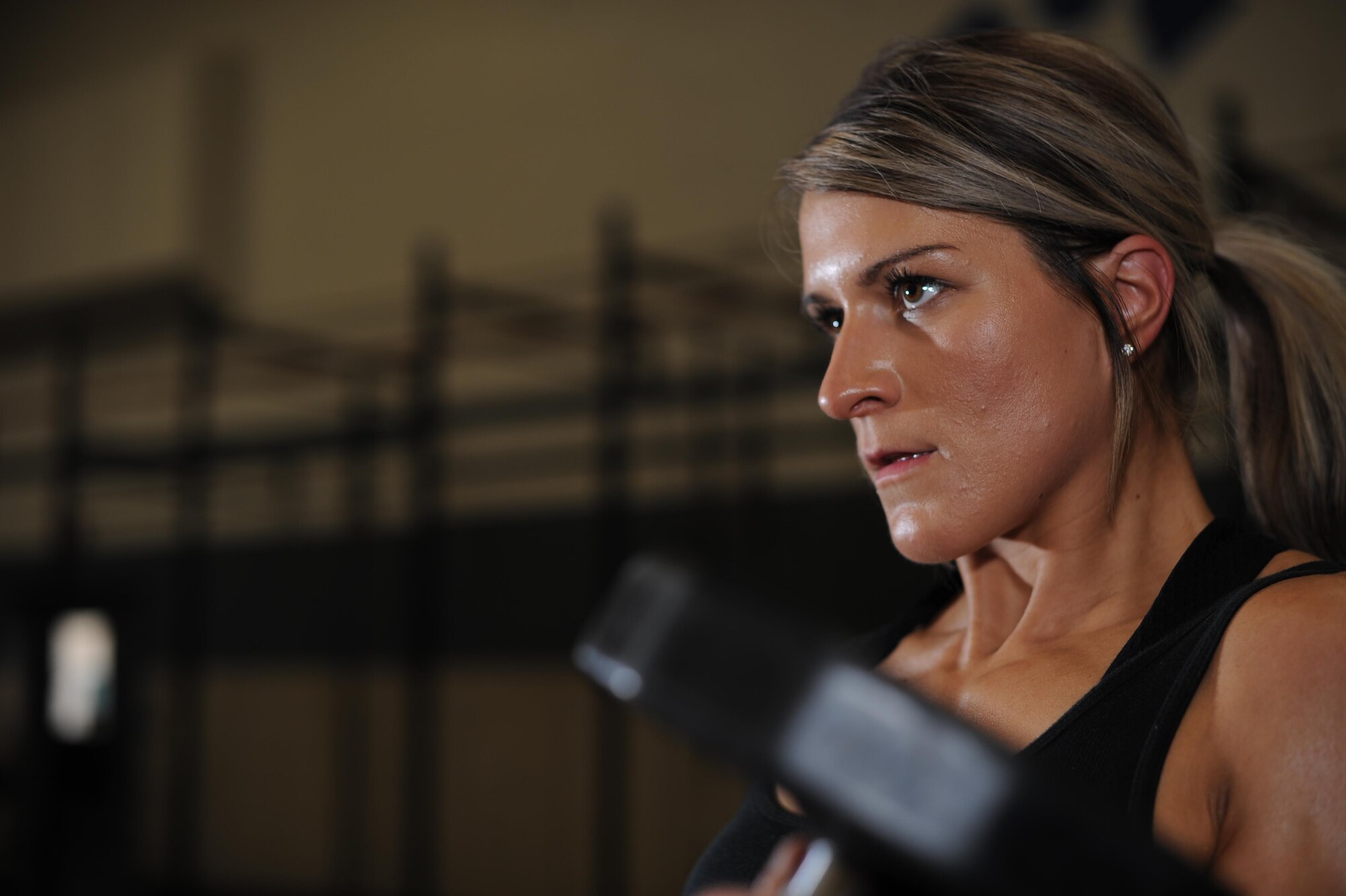 U.S. Air Force Staff Sgt. Macy Benjamin, 355th Contracting Squadron contract administrator, performs a dumbbell curl at the Haeffner Fitness and Sports Center at Davis-Monthan Air Force Base, Ariz., Aug. 25, 2016. Benjamin was motivated to begin weightlifting when she failed a physical fitness evaluation two years ago. (U.S. Air Force photo by Airman 1st Class Ashley N. Steffen)