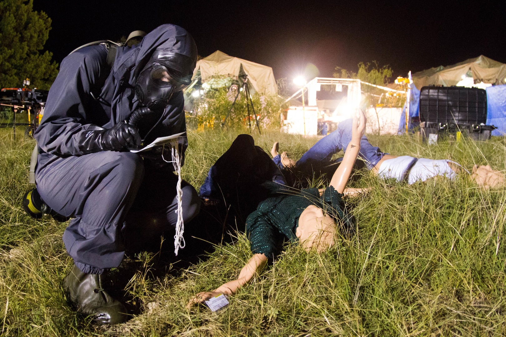 A Soldier with the 172nd Hazard Response Company from Fort Riley, Kansas examines a simulated injury Aug. 25, 2016 at Fort Hood, Texas during Exercise Sudden Response 16. The weeklong exercise was a key training event for the 172nd HR Co. and various other units within Joint Task Force Civil Support, a rapidly deployable force of more than 5,000 service members from across the country who are specially trained and equipped to provide life-saving assistance in the event of chemical, biological, radiological or nuclear disasters in the U.S. During the exercise, the Soldiers had to decontaminate and medically treat 200 civilian role players who acted as survivors of a nuclear attack. (U.S. Army photo by Sgt. Marcus Floyd, 13th Public Affairs Detachment)