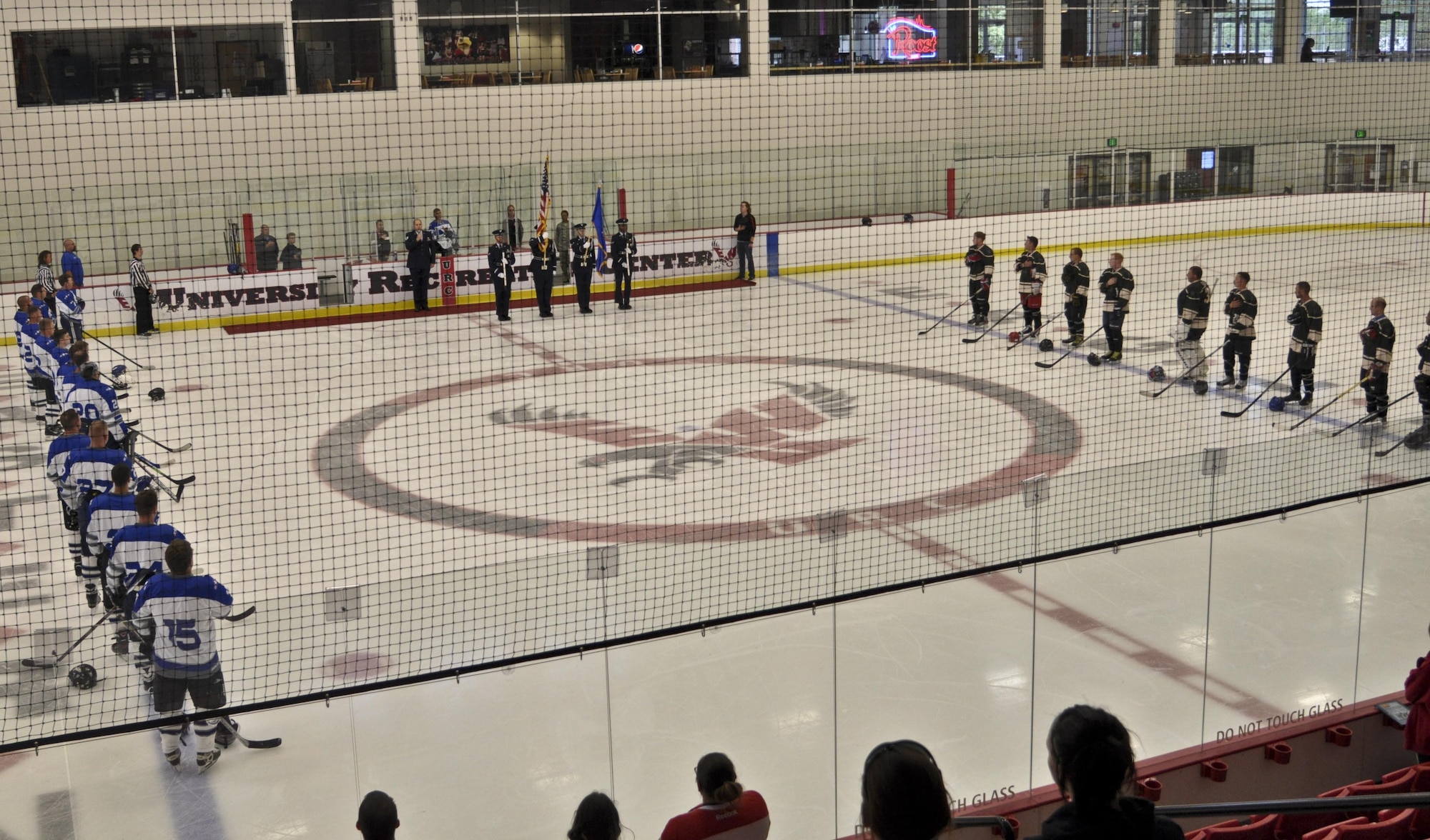 Hockey players from Fairchild Air Force Base, Wash and Joint Base Lewis-McChord, Wash. stand with their hands over their hearts while the National Anthem is being sung before the start of the Veterans Hockey Game Aug. 27, 2016 at Eastern Washington University Recreational Center in Cheney, Wash. The purpose of the game was to build relationships with other varsity hockey teams in the Pacific North West Region. (U.S. Air Force Photo/Airman 1st Class Taylor Shelton)