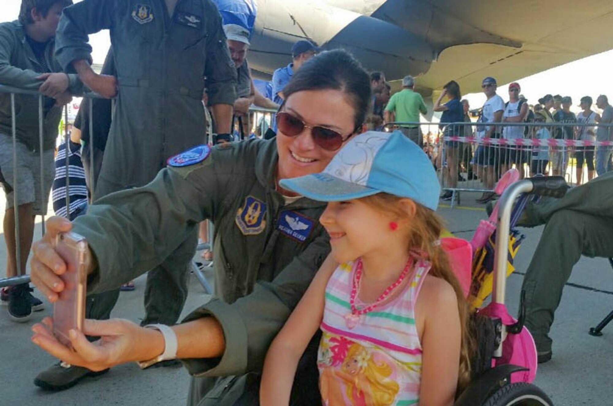 U.S. Air Force Maj. Heather Decker, a B-52 Stratofortress aircrew member with the 93rd Bomb Squadron, takes a selfie with a Slovak girl on Aug. 27, 2016 during the Slovak International Air Fest held in Sliač, Slovakia. The air show featured displays and aerial demonstrations with aircraft from across Europe and Asia; the B-52, from the Reserve 307th Bomb Wing, was the only U.S. representative at the event and was voted the best static display for the event. (U.S. Air Force photo by Master Sgt. Andrew Branning/Released)