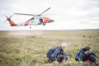 An MH-60 Jayhawk helicopter from U.S. Coast Guard Air Station Kodiak lands near simulated casualties for patient extraction during exercise Arctic Chinook, near Kotzebue, Alaska, August 24. Arctic Chinook is a joint U.S. Coast Guard and U.S. Northern Command sponsored exercise which focuses on multinational search and rescue readiness to respond to a mass rescue operation requirement in the Arctic. (U.S. Air National Guard photo by Staff Sgt, Edward Eagerton/released)