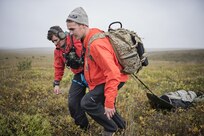 Pararescuemen from the 212th Rescue Squadron, Alaska Air National Guard, move a simulated casualty to a casualty collection point during exercise Arctic Chinook, near Kotzebue, Alaska, August 23. Arctic Chinook is a joint U.S. Coast Guard and U.S. Northern Command sponsored exercise which focuses on multinational search and rescue readiness to respond to a mass rescue operation requirement in the Arctic. (U.S. Air National Guard photo by Staff Sgt, Edward Eagerton/released)