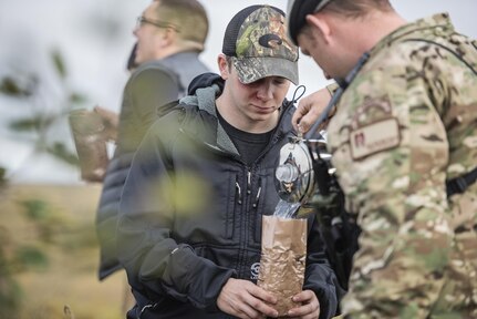 Simulated casualties are provided food by members of the 212th Rescue Squadron from food provided by the Arctic Sustainment Package during exercise Arctic Chinook, near Kotzebue, Alaska, August 23. Arctic Chinook is a joint U.S. Coast Guard and U.S. Northern Command sponsored exercise which focuses on multinational search and rescue readiness to respond to a mass rescue operation requirement in the Arctic. (U.S. Air National Guard photo by Staff Sgt, Edward Eagerton/released)