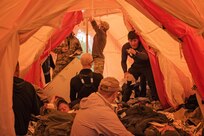 Pararescuemen from the 212th Rescue Squadron, Alaska Air National Guard, triage simulated casualties inside their Arctic Sustainment Package tent during exercise Arctic Chinook, near Kotzebue, Alaska, August 23. Arctic Chinook is a joint U.S. Coast Guard and U.S. Northern Command sponsored exercise which focuses on multinational search and rescue readiness to respond to a mass rescue operation requirement in the Arctic. (U.S. Air National Guard photo by Staff Sgt, Edward Eagerton/released)