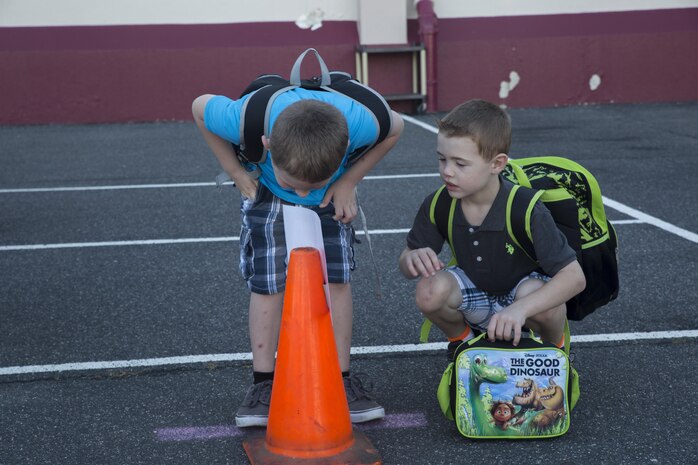Students line up at cones that correspond with what grade level they are entering on Matthew C. Perry’s first day of school on Marine Corps Air Station Iwakuni, Japan, Aug. 29, 2016. This school year differs from others as it is the last time the first day of school will be held at the current facility. Students will transition to the newly constructed schools halfway through the school year. (U.S. Marine Corps photo by Cpl. Nathan Wicks)