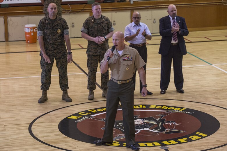 Col. Richard Fuerst, commanding officer of Marine Corps Air Station Iwakuni, addresses the students of Matthew C. Perry during the first day of school on MCAS Iwakuni, Japan, Aug. 29, 2016. Staff members let students know of their expectations and what they can look forward to as they begin their school year. (U.S. Marine Corps photo by Cpl. Nathan Wicks)