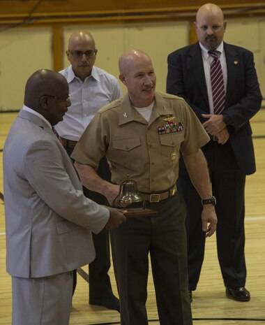 Col. Richard Fuerst, commanding officer of Marine Corps Air Station Iwakuni, ‘rings in’ the school year during Matthew C. Perry’s first day of school on MCAS Iwakuni, Japan, Aug. 29, 2016. Staff members let students know of their expectations and what they can look forward to as they begin their school year. (U.S. Marine Corps photo by Cpl. Nathan Wicks)