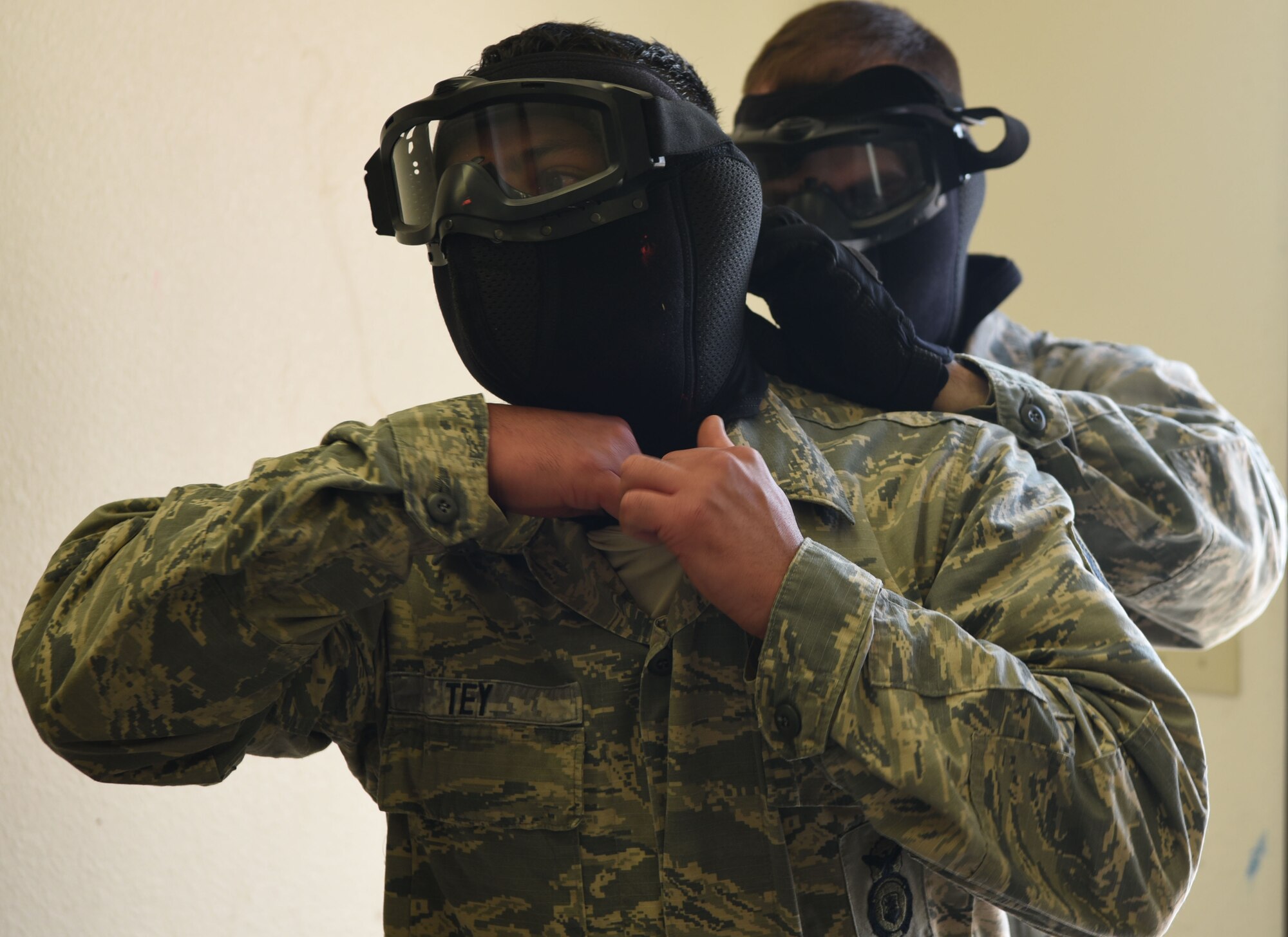 Airmen from the 90th Security Support Squadron secure their masks for an active-shooter scenario during the annual Crow Creek Challenge at F.E. Warren Air Force Base, Wyo., Aug. 26, 2016. Their personal protective equipment kept them safe during the exercise. The 22nd CCC tested defenders’ mission capabilities as a team in a physically and mentally stressful environment. (U.S. Air Force photo by Airman 1st Class Breanna Carter) 