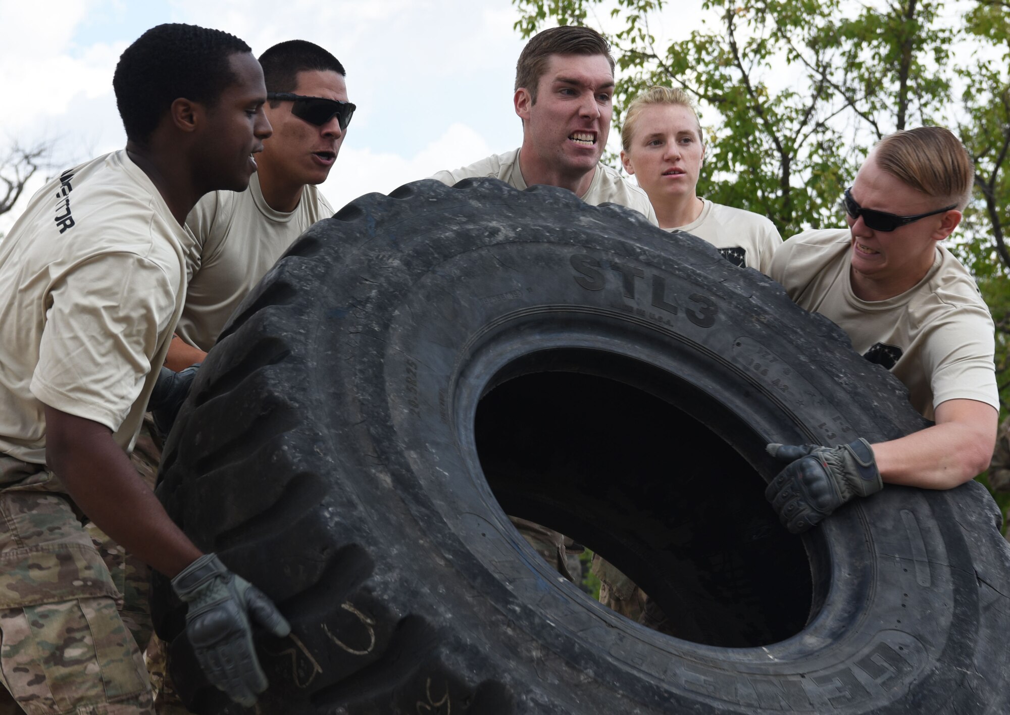 Airmen from the 90th Missile Security Forces Squadron flip a tire during the annual Crow Creek Challenge at F.E. Warren Air Force Base, Wyo., Aug. 26, 2016. This was one portion of team pain, a purely physical event. The 22nd CCC tested defenders’ mission capabilities as a team in a physically and mentally stressful environment. (U.S. Air Force photo by Airman 1st Class Breanna Carter)