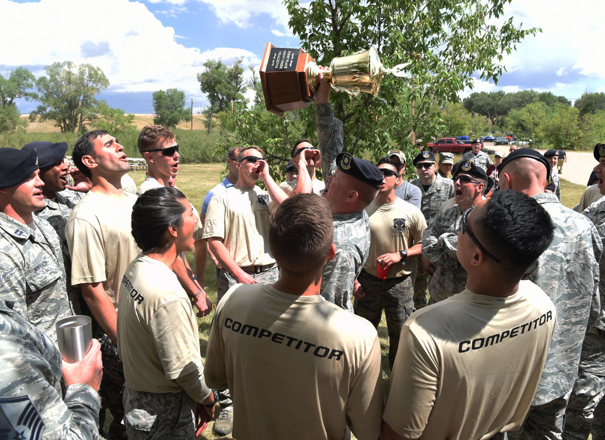 Airmen from the 90th Security Forces Squadron celebrate their victory after the annual Crow Creek Challenge at F.E. Warren Air Force Base, Wyo., Aug. 26, 2016. The 90th Security Forces Squadron was awarded a trophy for completing the course the fastest. The 22nd CCC tested defenders’ mission capabilities as a team in a physically and mentally stressful environment. (U.S. Air Force photo by Airman 1st Class Breanna Carter)