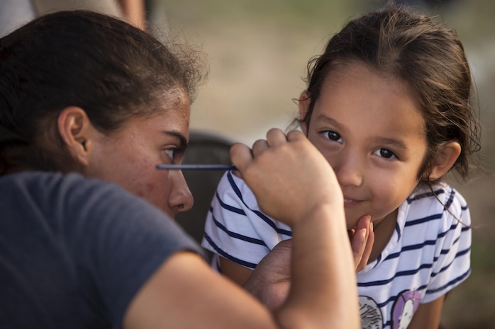 Lance Cpl. Laura Mosquera, a warehouse clerk with Combat Logistics Company 36, paints a child’s face during the Summer Music Festival hosted by Marine Corps Community Services at Marine Corps Air Station Iwakuni, Japan, Aug. 27, 2016. Mosquera participated in the festival as a volunteer to help out MCCS and the event. The Summer Music Festival was put together for service members, residents and Japanese locals to enjoy the end of the summer with free music, food and fun. (U.S. Marine Corps photo by Lance Cpl. Donato Maffin)