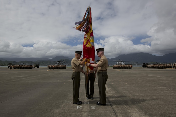 Lt. Gen. John A. Toolan, the outgoing commander of U.S. Marine Corps Forces, Pacific, passes the unit colors to Lt. Gen. David H. Berger during a change of command ceremony at Marine Corps Base Hawaii, Aug. 26, 2016. The change of command ceremony represents the transfer of responsibility and authority between commanders. (U.S. Marine Corps photo by Lance Cpl. Matthew Casbarro/Released)