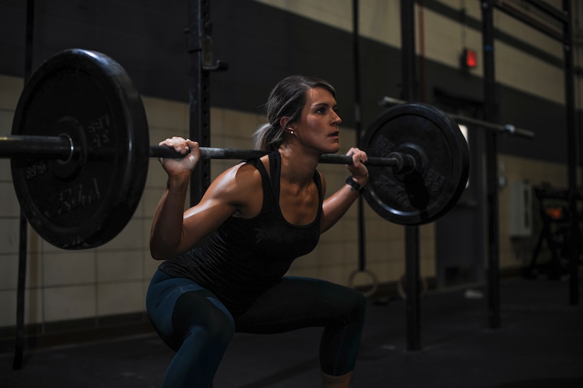 U.S. Air Force Staff Sgt. Macy Benjamin, 355th Contracting Squadron contract administrator, performs a squat exercise at the Haeffner Fitness and Sports Center at Davis-Monthan Air Force Base, Ariz., Aug. 25, 2016. Benjamin has used fitness to boost her self-esteem and finds happiness within her workouts. (U.S. Air Force photo by Airman 1st Class Ashley N. Steffen)