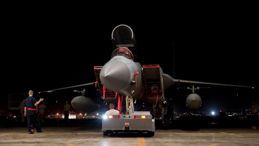 Maintainers assigned to the 67th Aircraft Maintenance Unit maneuver an F-15 Eagle out of an aircraft hangar Aug. 24, 2016, at Kadena Air Base, Japan. Airmen worked during the night to prepare aircraft for a possible typhoon that was postured to hit Okinawa. (U.S. Air Force photo by Senior Airman Peter Reft)