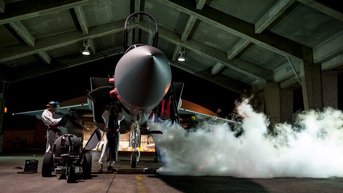 Airman Marquel Marshall and Airman 1st Class Darris Little, 67th Aircraft Maintenance Unit F-15 Eagle crew chiefs, service a liquid oxygen converter on the flightline Aug. 24, 2016, at Kadena Air Base, Japan. Marshal and Little work as swing shift maintainers, ensuring round-the-clock mission readiness of Kadena’s F-15s. (U.S. Air Force photo by Senior Airman Peter Reft)