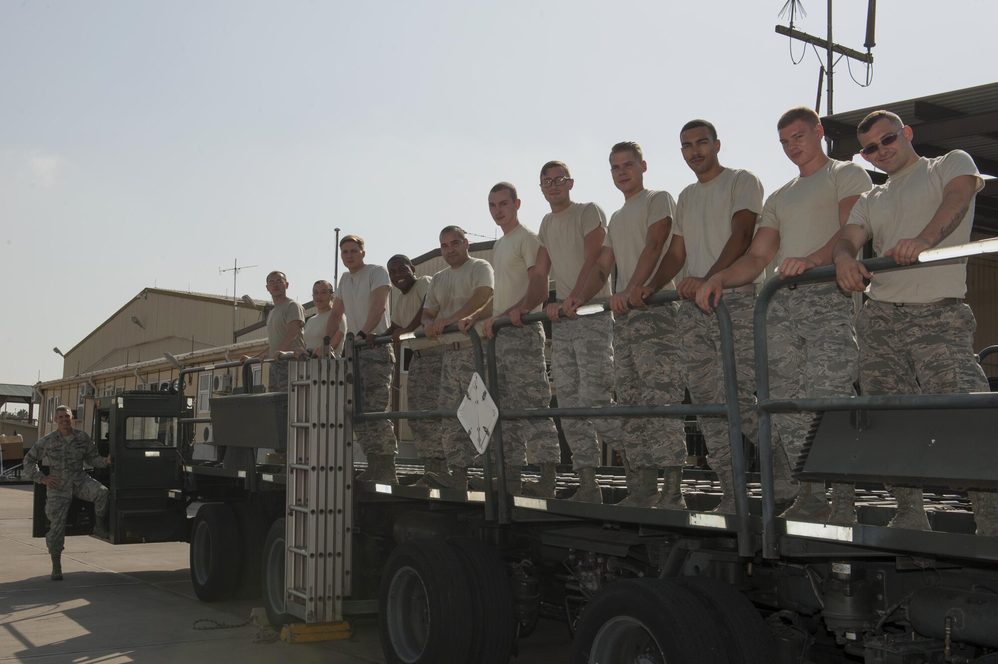 U.S. Air Force Airmen from the 728th Air Mobility Squadron stand on a K-Loader, while their commander Lt. Col. Nathan Mansfield stands next to it Aug. 25, 2016, at Incirlik Air Base Turkey.  K-Loaders are used to upload and off load cargo from aircraft and have a load capacity of up to 44,000 pounds. (U.S. Air Force photo by Staff Sgt. Jack Sanders)
