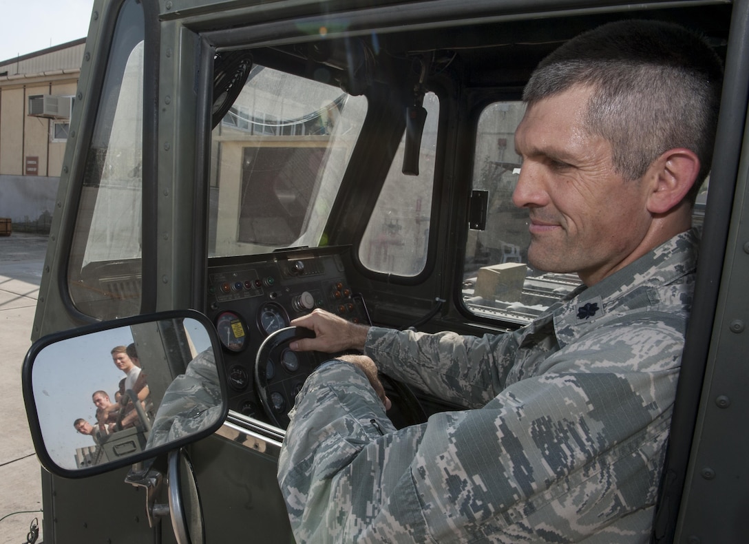 U.S. Air Force Lt. Col. Nathan Mansfield, 728th Air Mobility Squadron (AMS) commander, sits in a K-Loader watching the Airmen from his squadron in the side mirror Aug. 25, 2016, at Incirlik Air Base, Turkey. Mansfield took command of the 728th AMS June 9, 2016. (U.S. Air Force photo by Staff Sgt. Jack Sanders)