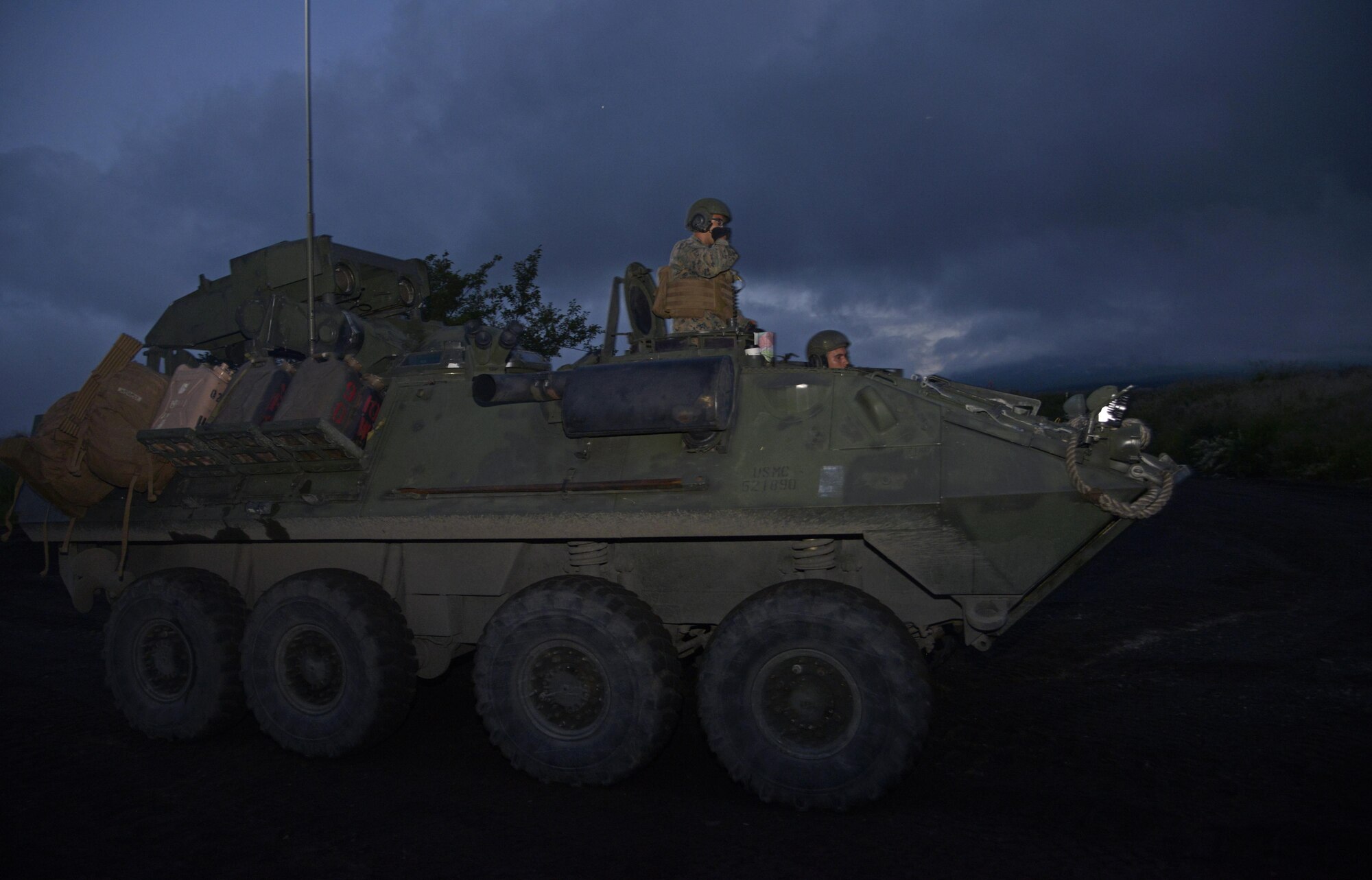 Marines sit on a light-armored vehicle at a training ground near Camp Fuji, Japan, Aug. 24, 2016. The Marines honed their combat mobility techniques throughout the day, allowing photo enthusiasts from Yokota Air Base to practice their photography skills simultaneously. (U.S. Air Force photo by Senior Airman David Owsianka/Released)