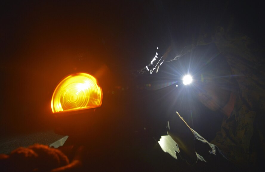 A Marine repairs a light on an LAV during a training scenario in a field near Camp Fuji, Japan, Aug. 24, 2016. The LAV is an eight-wheeled amphibious armored reconnaissance vehicle that is armed with an M242 25mm chain gun and two M240 machine guns. (U.S. Air Force photo by Senior Airman David Owsianka/Released)