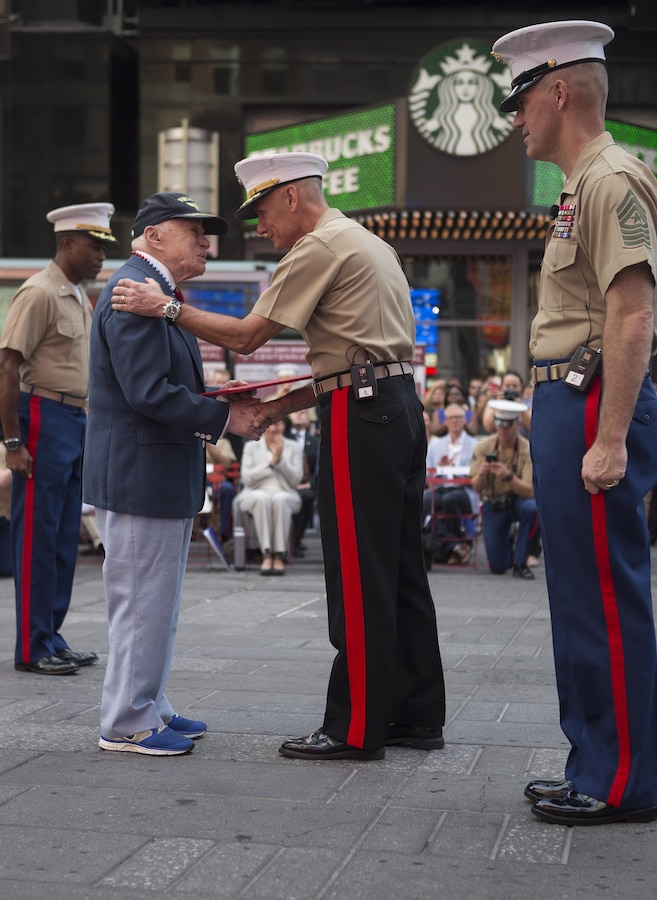 Lt. Gen. Rex C. McMillian recognizes retired Col. Jon Mendes for his distinguished service in the Marine Corps during the U.S. Marine Corps Reserve Centennial celebration at Times Square, Aug. 29, 2016. For 100 years, the Marine Corps Reserve has answered the call, serving as our nation’s crisis response force and expeditionary force in readiness. The centennial celebration is a way to honor this selfless service and commemorate the Marine Corps’ rich history, heritage and esprit de corps. It also provides an opportunity to thank their families, employers and community for their continued support. (U.S. Marine Corps photo by Sgt. Sara Graham)