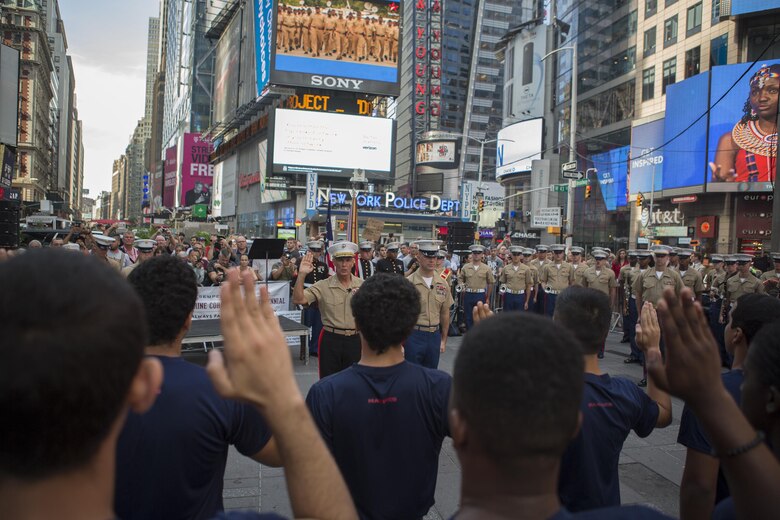 Lt. Gen. Rex C. McMillian, commander of Marine Forces Reserve and Marine Forces North, gives the oath of enlistment to potential recruits during the U.S. Marine Corps Forces Reserve Centennial celebration at Times Square, Aug. 29, 2016. For 100 years, the Marine Corps Reserve has answered the call, serving as our nation’s crisis response force and expeditionary force in readiness. The centennial celebration is a way to honor this selfless service and celebrate the Marine Corps’ rich history, heritage and esprit de corps. (U.S. Marine Corps photo by Sgt. Sara Graham)