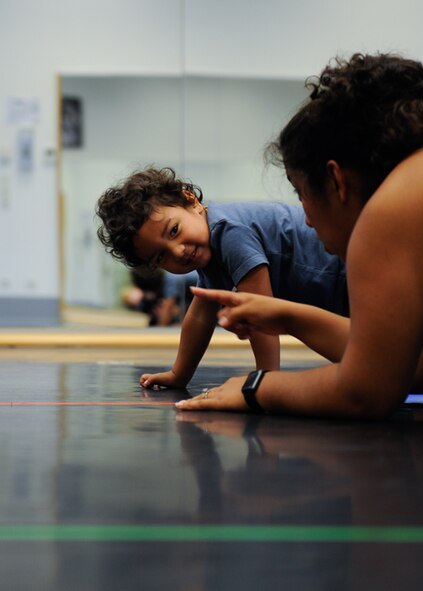 Roy Barrios watches his mother, Kadyzshea Barrios, during a Mommy and Me Yoga class Aug. 29, 2016, at Ramstein Air Base, Germany. The Mommy and Me Yoga course is offered every Monday, starting Aug. 29. (U.S. Air Force photo/ Airman 1st Class Savannah L. Waters)